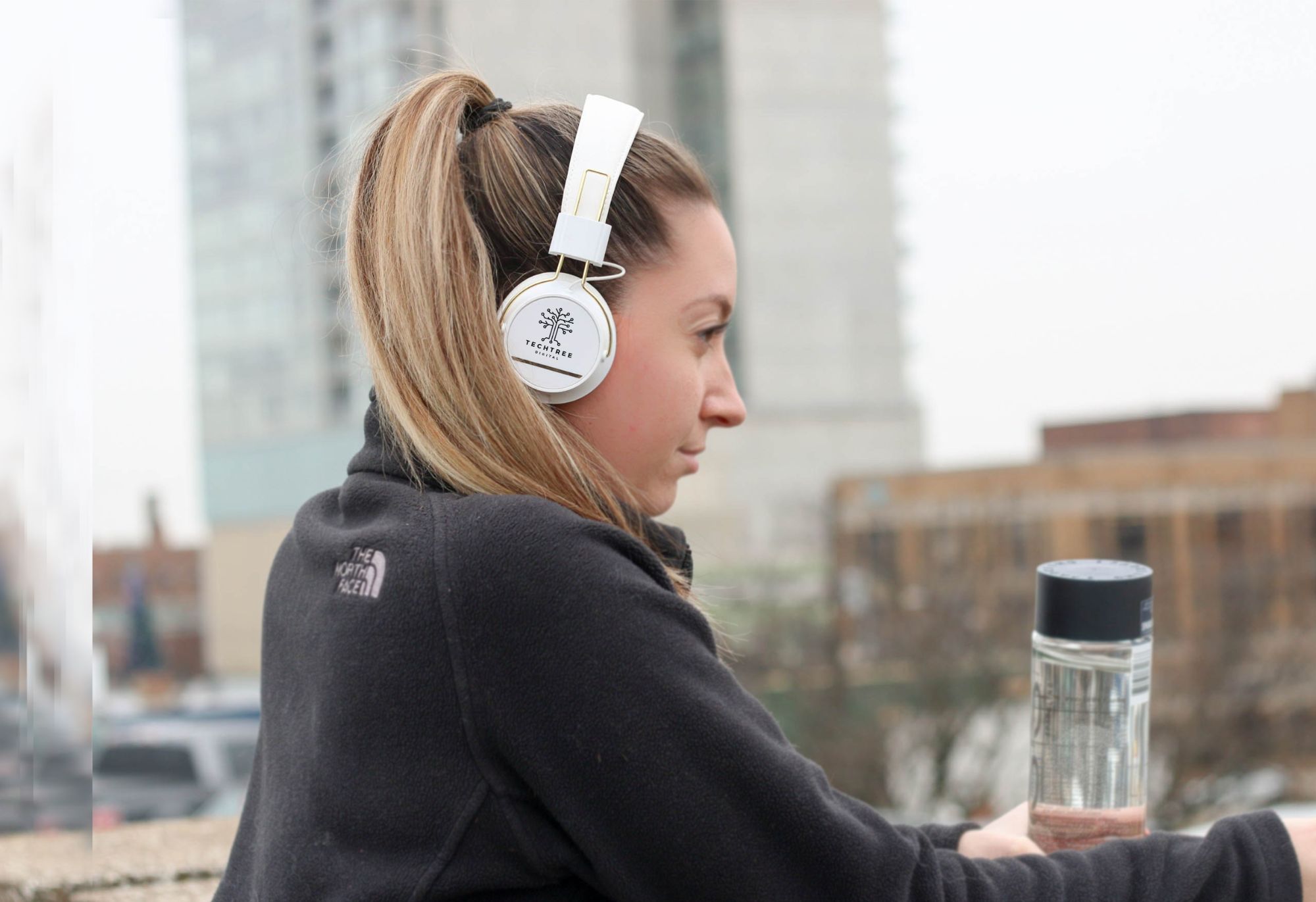 woman wearing decorated headphones with TechTree in New Orleans, LA logo